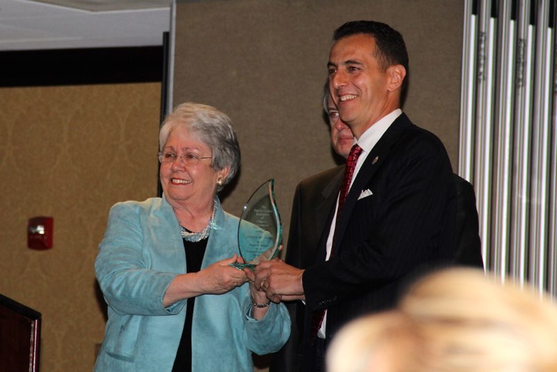 Kate Hanley and Marcus Simon accept Jim Scott's Special Gratitude Award while he takes a long deserved vacation out of the country